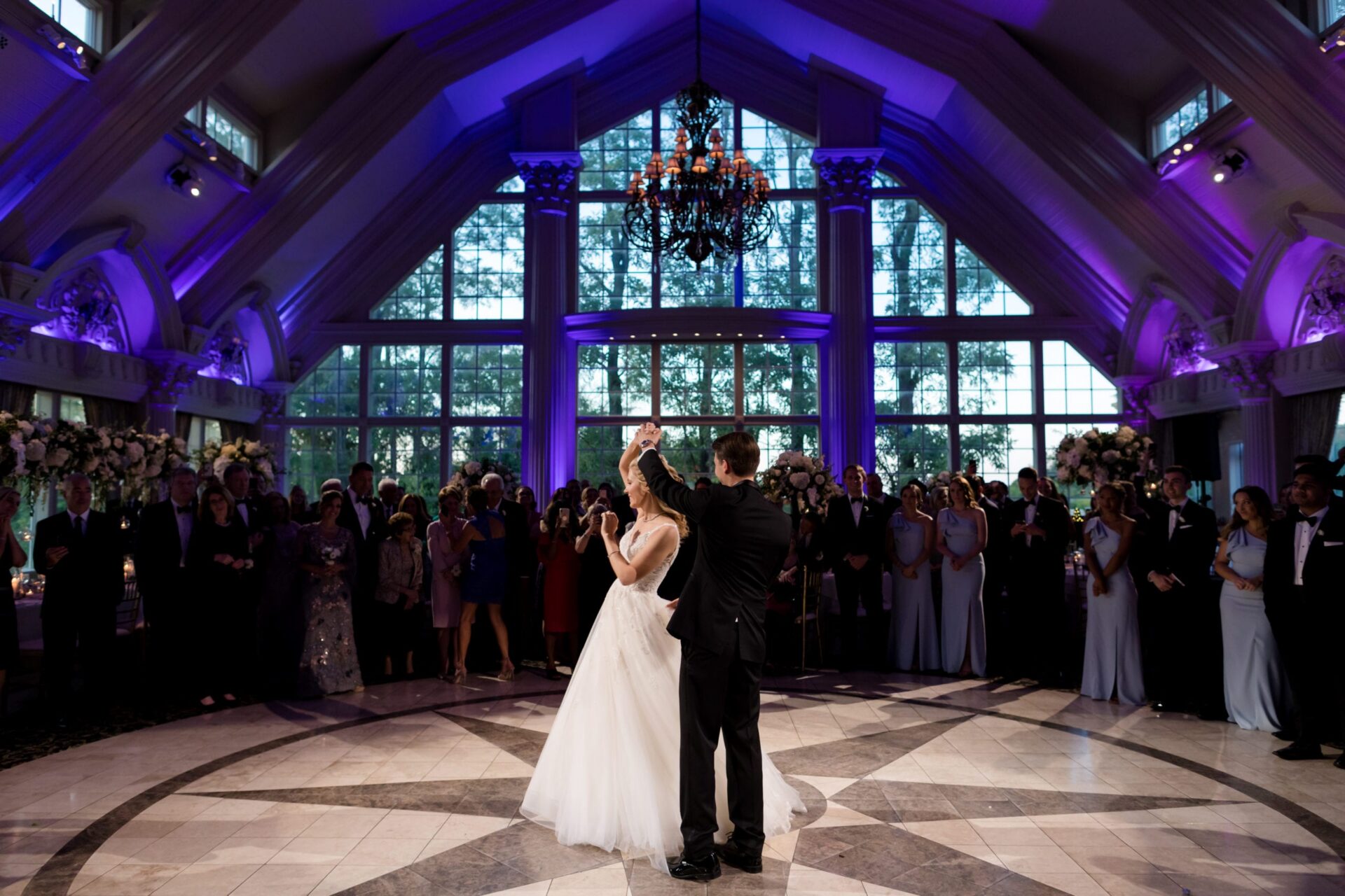 Bride and groom's first dance in the Ashford Estate ballroom under purple uplighting